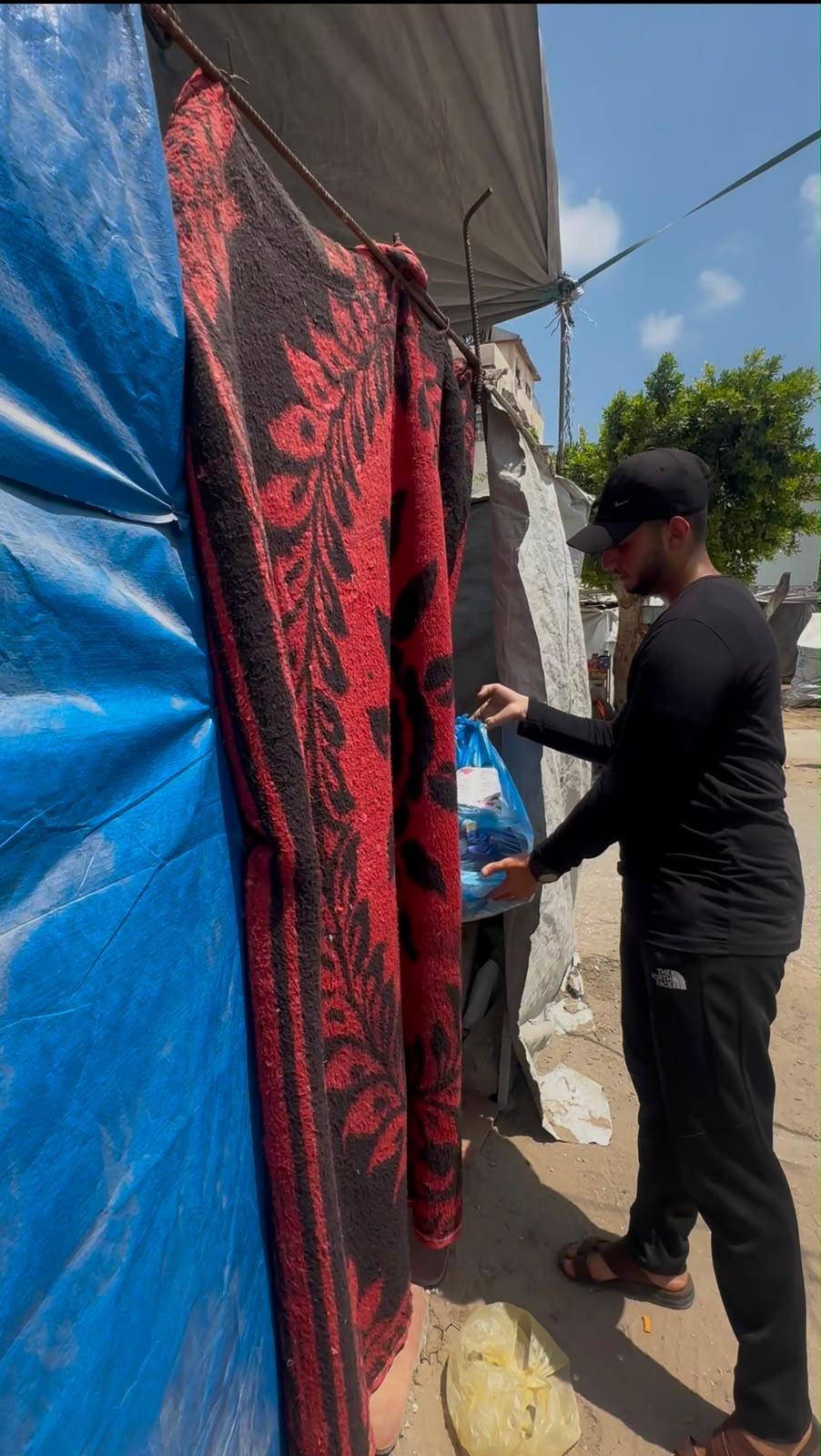 Volunteer delivering aid at a tent