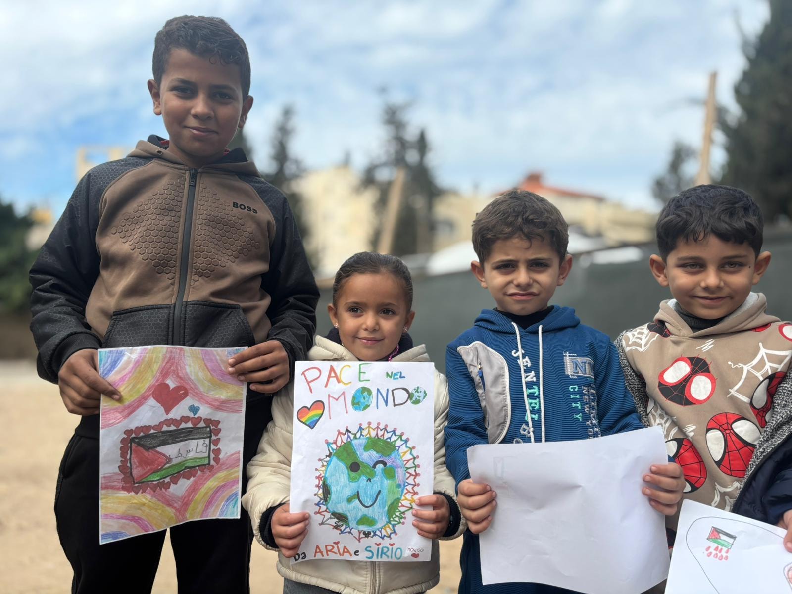 Children holding peace drawings
